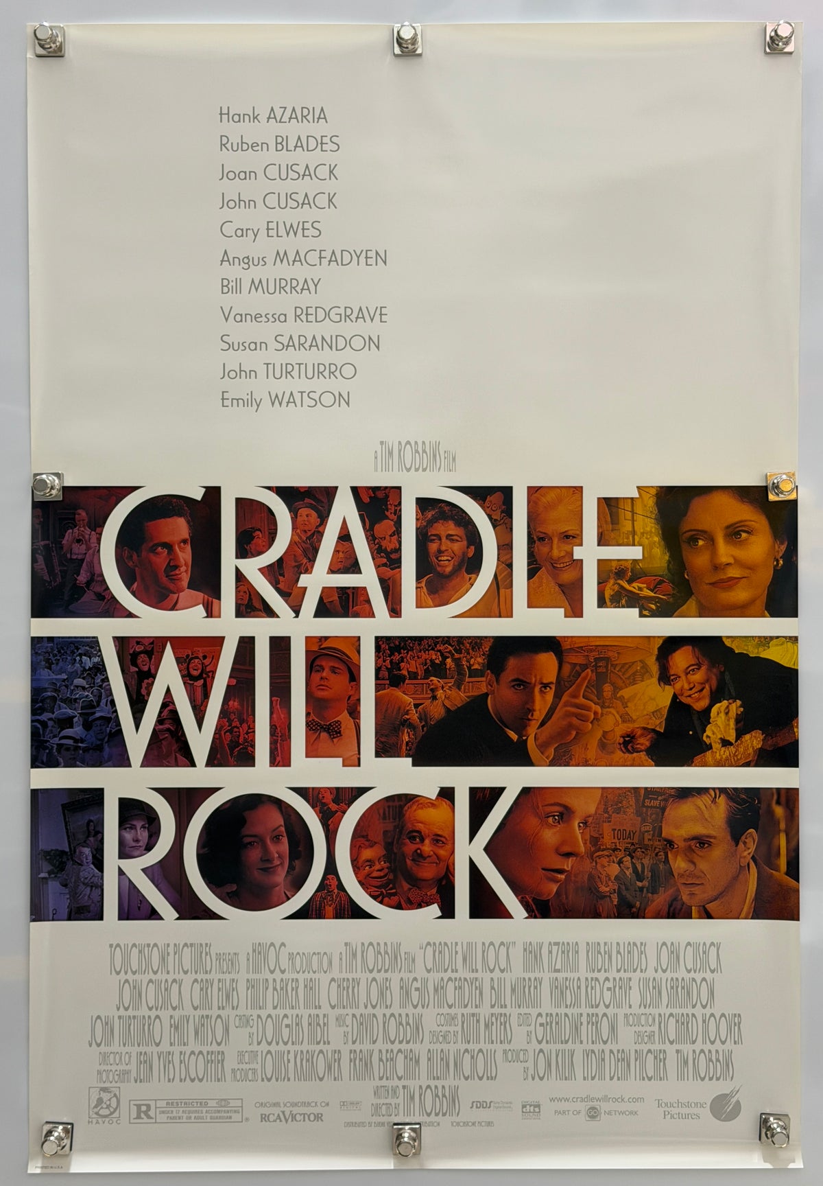 A vintage movie poster for the film 'Cradle Will Rock' displayed flat against a white background with visible mounting clips at the corners.