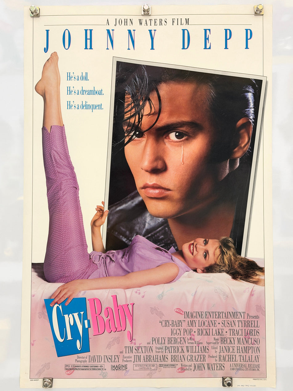 Cry-Baby theatrical movie poster with a large portrait of Johnny Depp, Amy Locane in purple, and the tagline He’s a doll. He’s a dreamboat. He’s a delinquent.