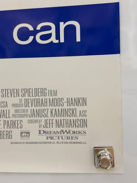 A close-up of a printed movie poster or cover for the film 'can', showing a blue vertical band with the word 'can' in large white letters on the left, a white background with film credits in black text, and a small metallic logo near the top right.