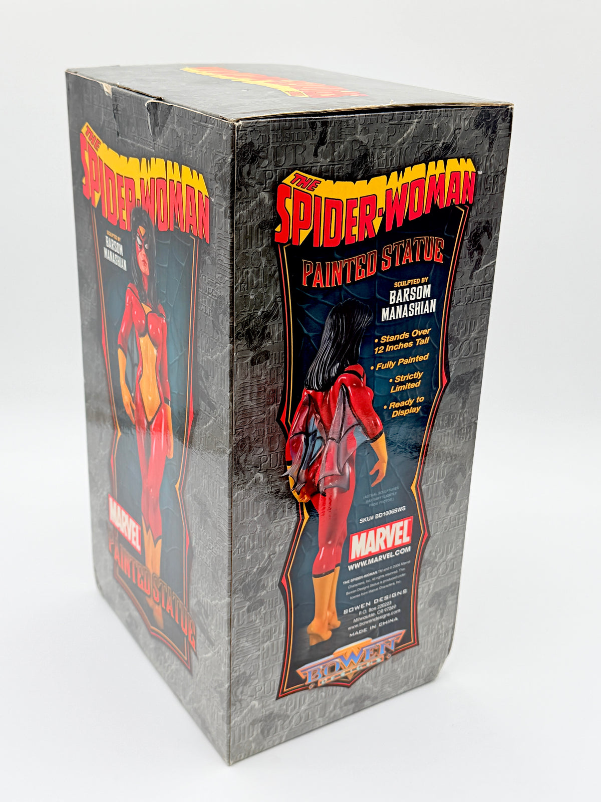 Vintage Marvel Spider-Woman painted statue box, featuring a gray textured background with red and yellow Spider-Woman graphics and an illustration of Betsy Ross Hanasham.