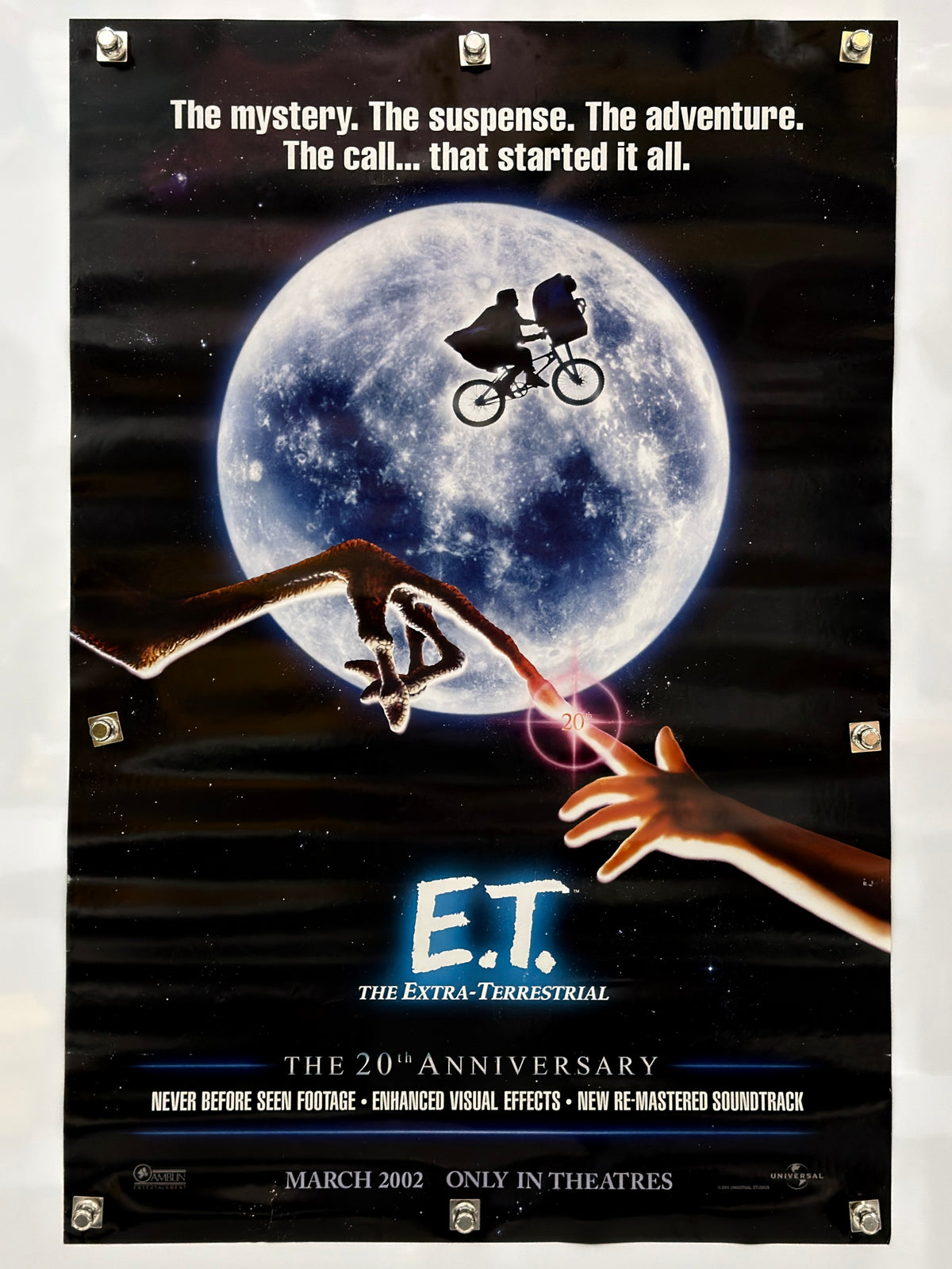 E.T. 20th anniversary advance poster with bicycle silhouette across the moon, touching fingers, and March 2002 theatrical release text.